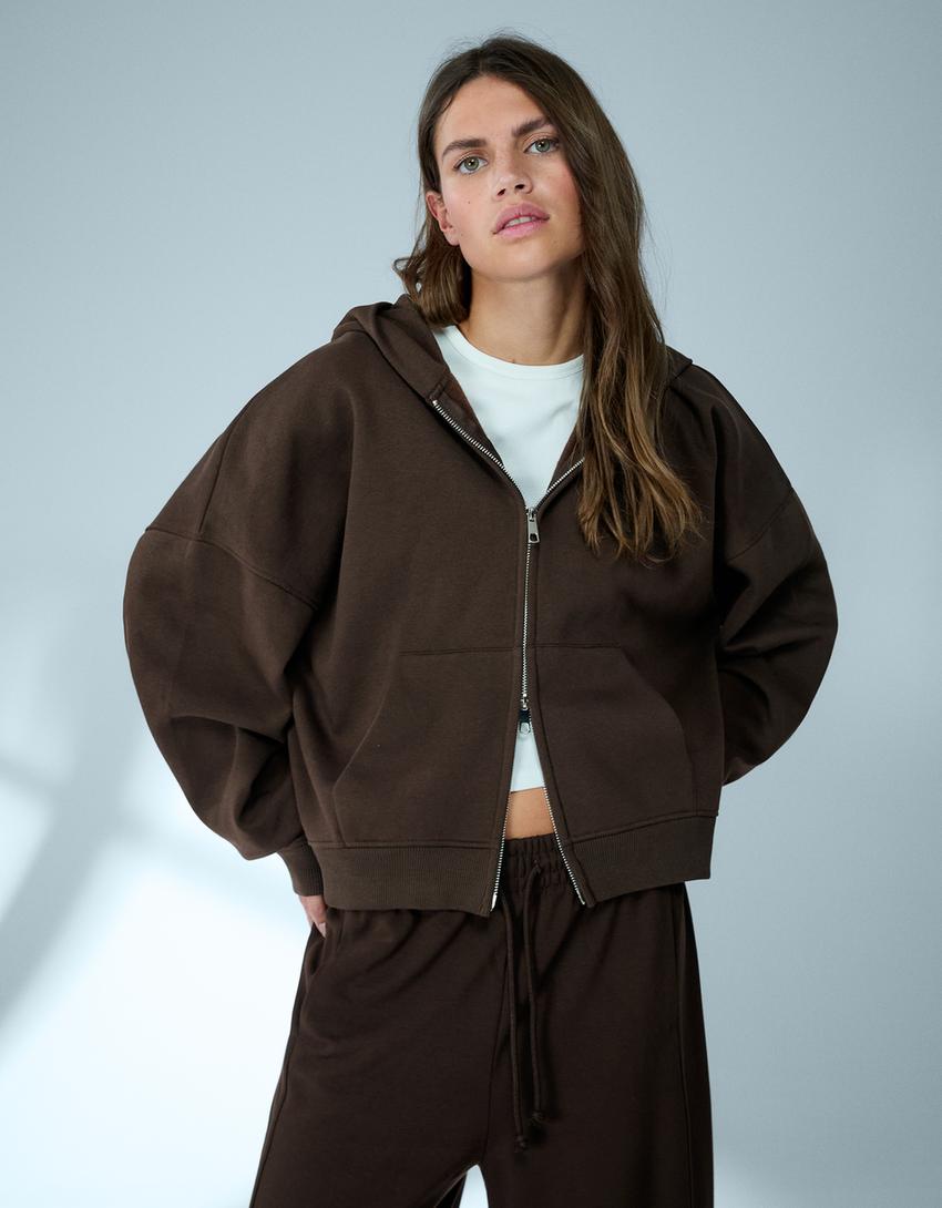 SWEAT ZIPPÉ OVERSIZE À CAPUCHE