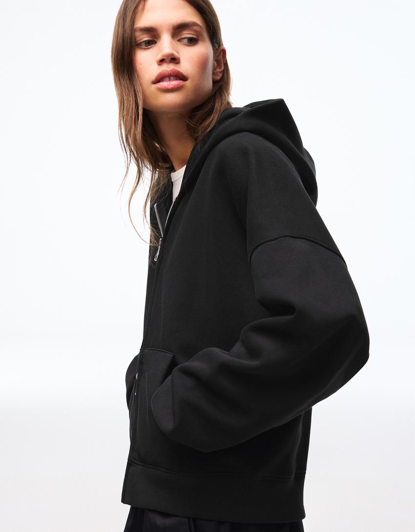 SWEAT ZIPPÉ OVERSIZE À CAPUCHE