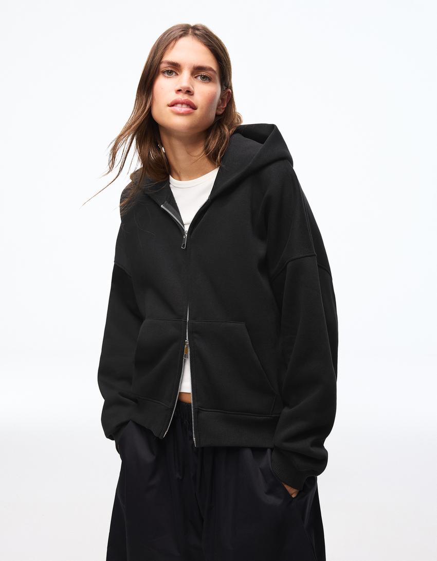 SWEAT ZIPPÉ OVERSIZE À CAPUCHE