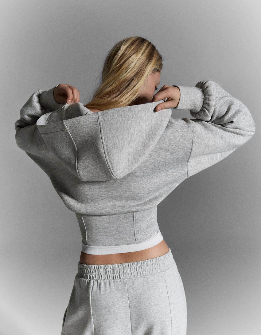 SWEAT ZIPPÉ À CAPUCHE TAILLE HAUTE
